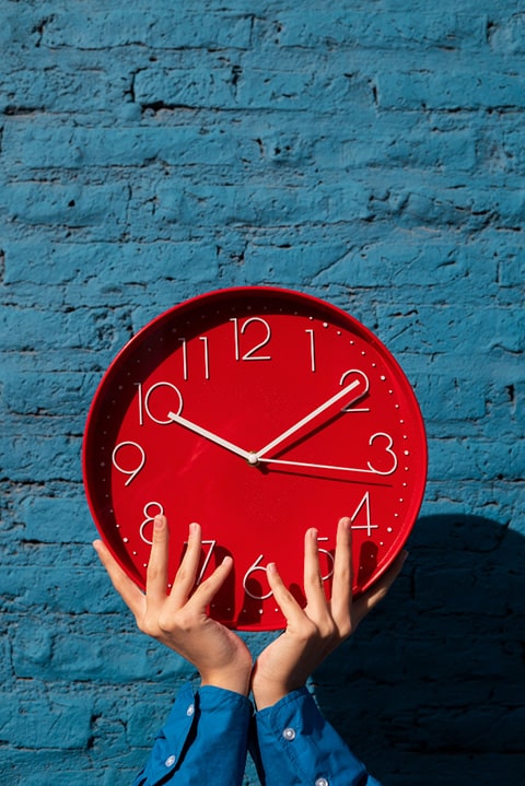 hands-holding-wall-clock-still-life