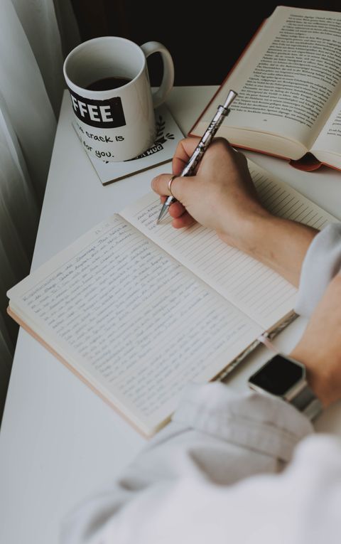person-writing-on-notebook