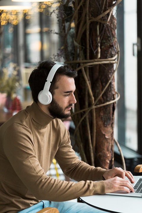 high-angle-business-man-with-headphones-working